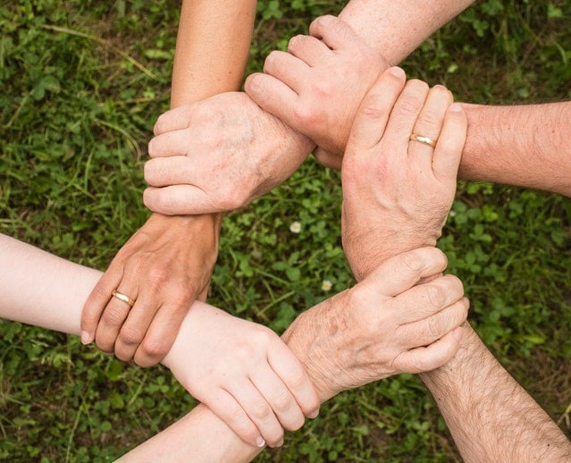 family with generational wealth holding hands