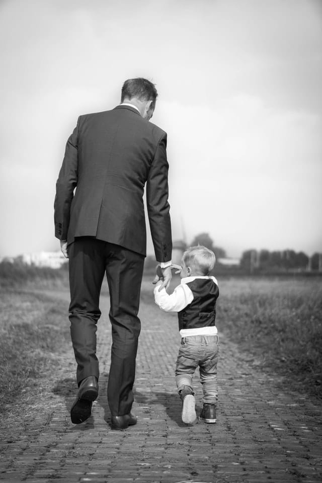 father walking with son who he'll pass generational wealth to