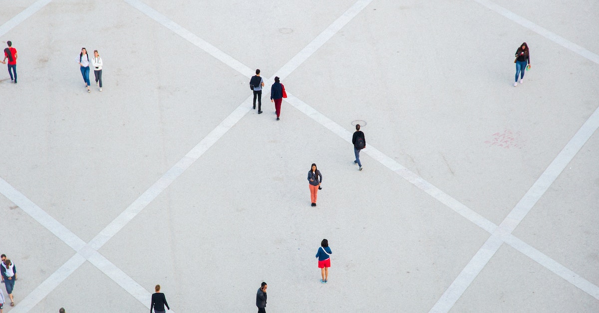 aerial image of people on pavement alienated from one another